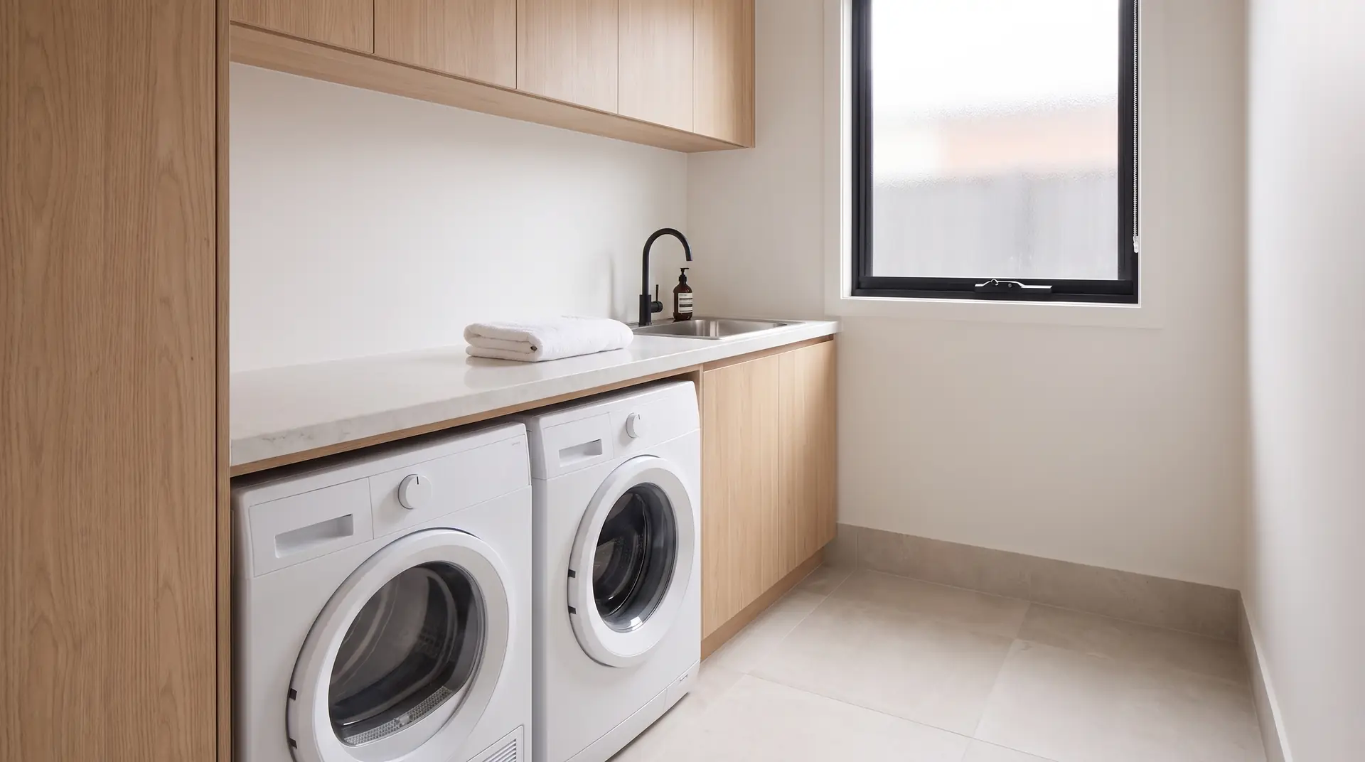 Illustration: a laundry with built-in cabinetry, a washer and a dryer, the kind of fittings a depreciation schedule lists