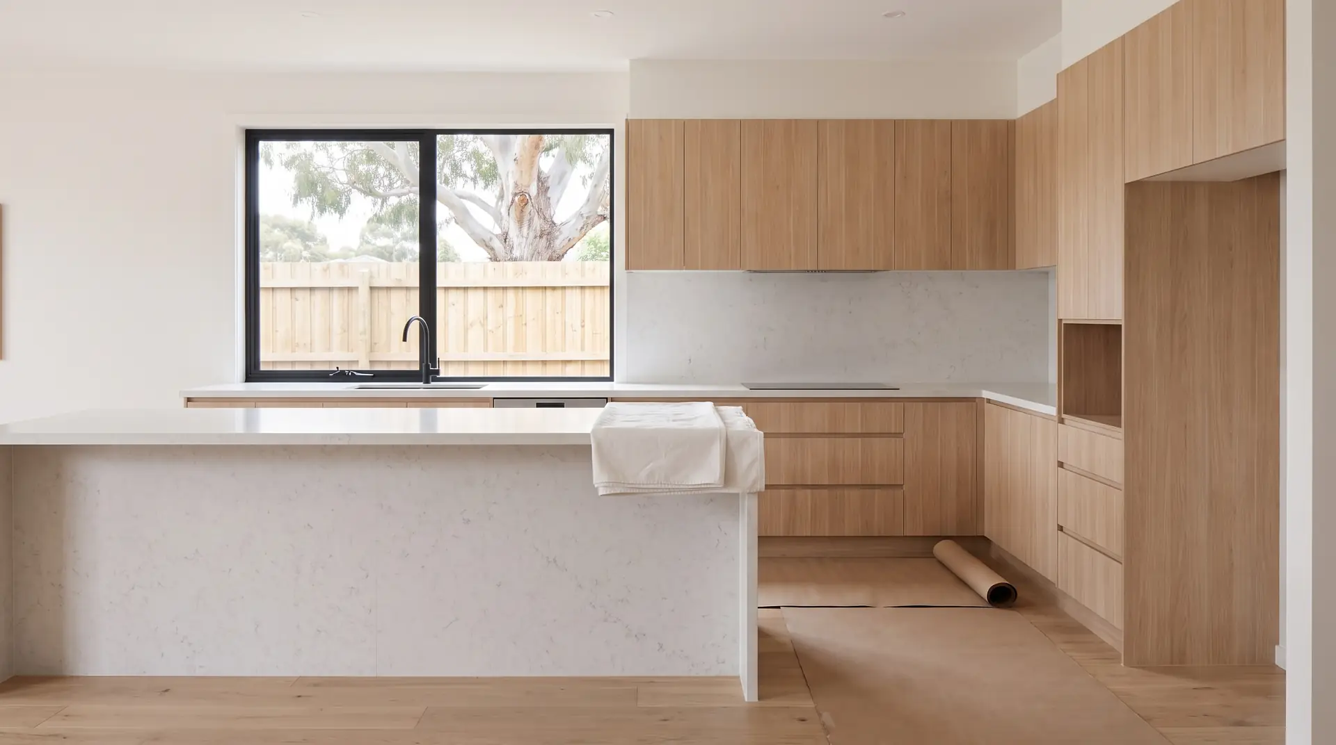 Illustration: a brand-new, empty kitchen on handover day, the finishes a handover inspection walks through with you