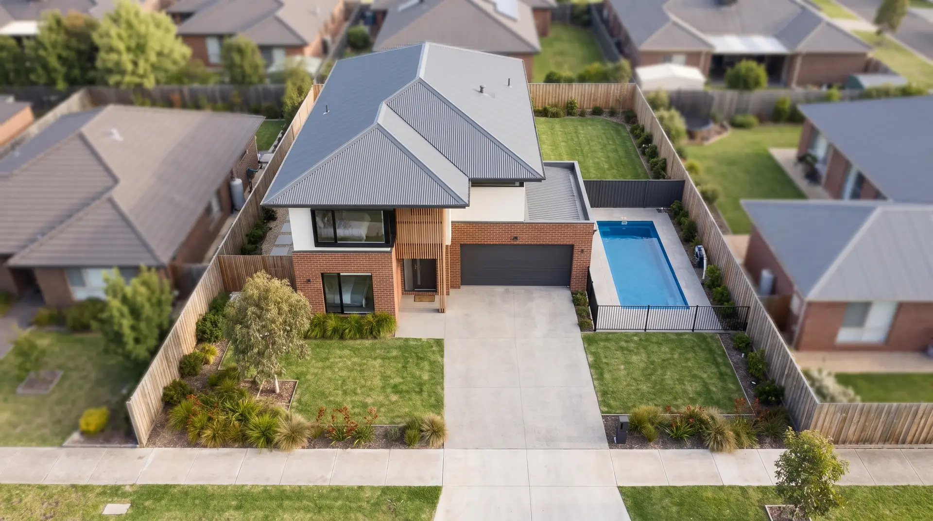 Illustration: the home, pool, driveway and fenced block seen from directly above, neighbours either side