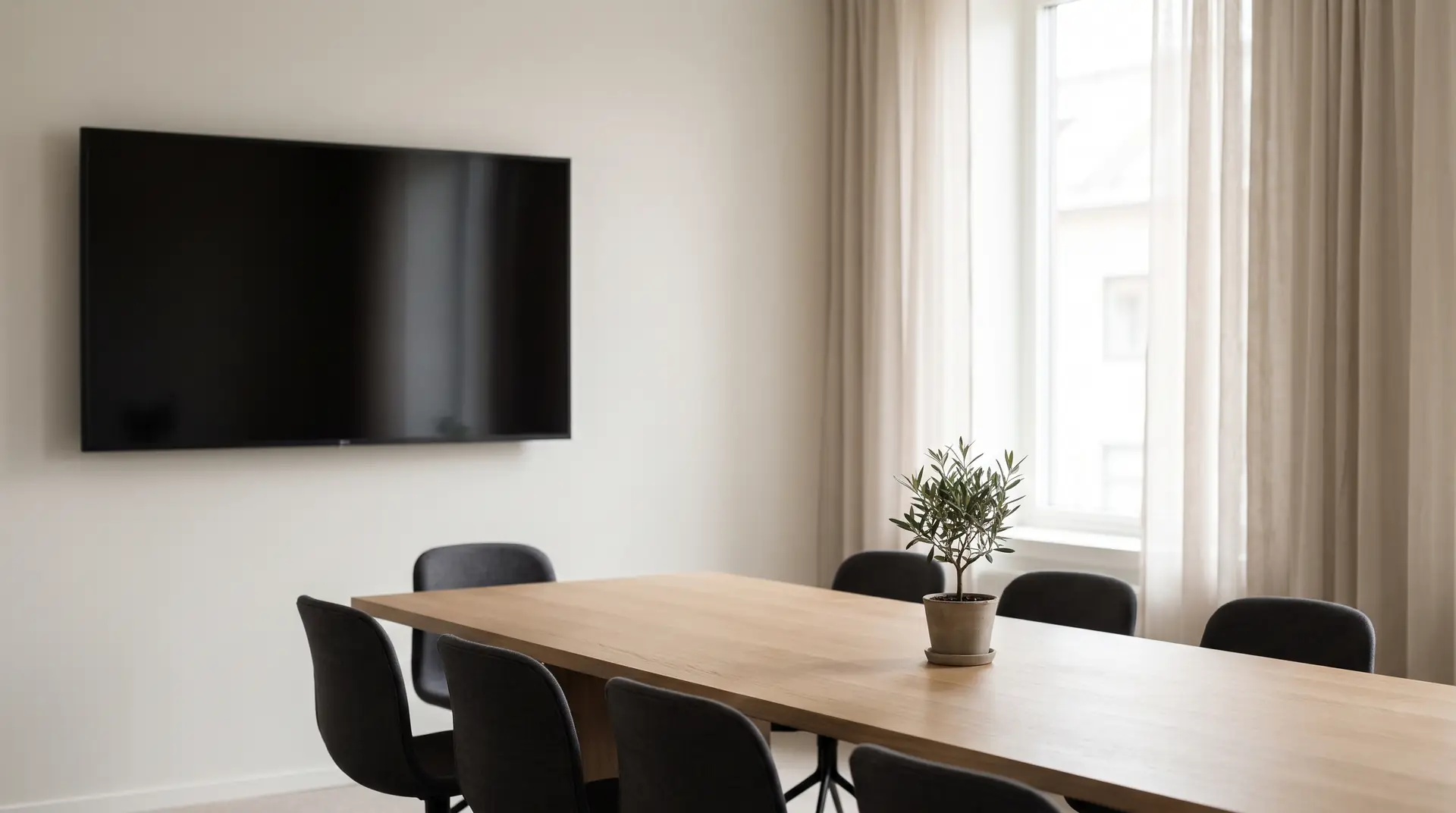 Illustration: a meeting room with a long oak table, chairs and a wall screen, sheer curtains at the window